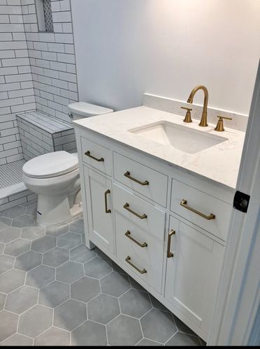 Bathroom vanity with gold hardware and hex tile